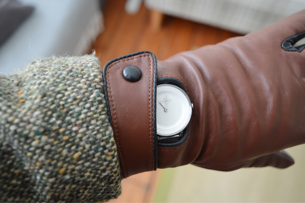 Hayley Angell watch displaying 11am and beginning of vintage style challenge with brown leather vintage cloves and tweed jacket
